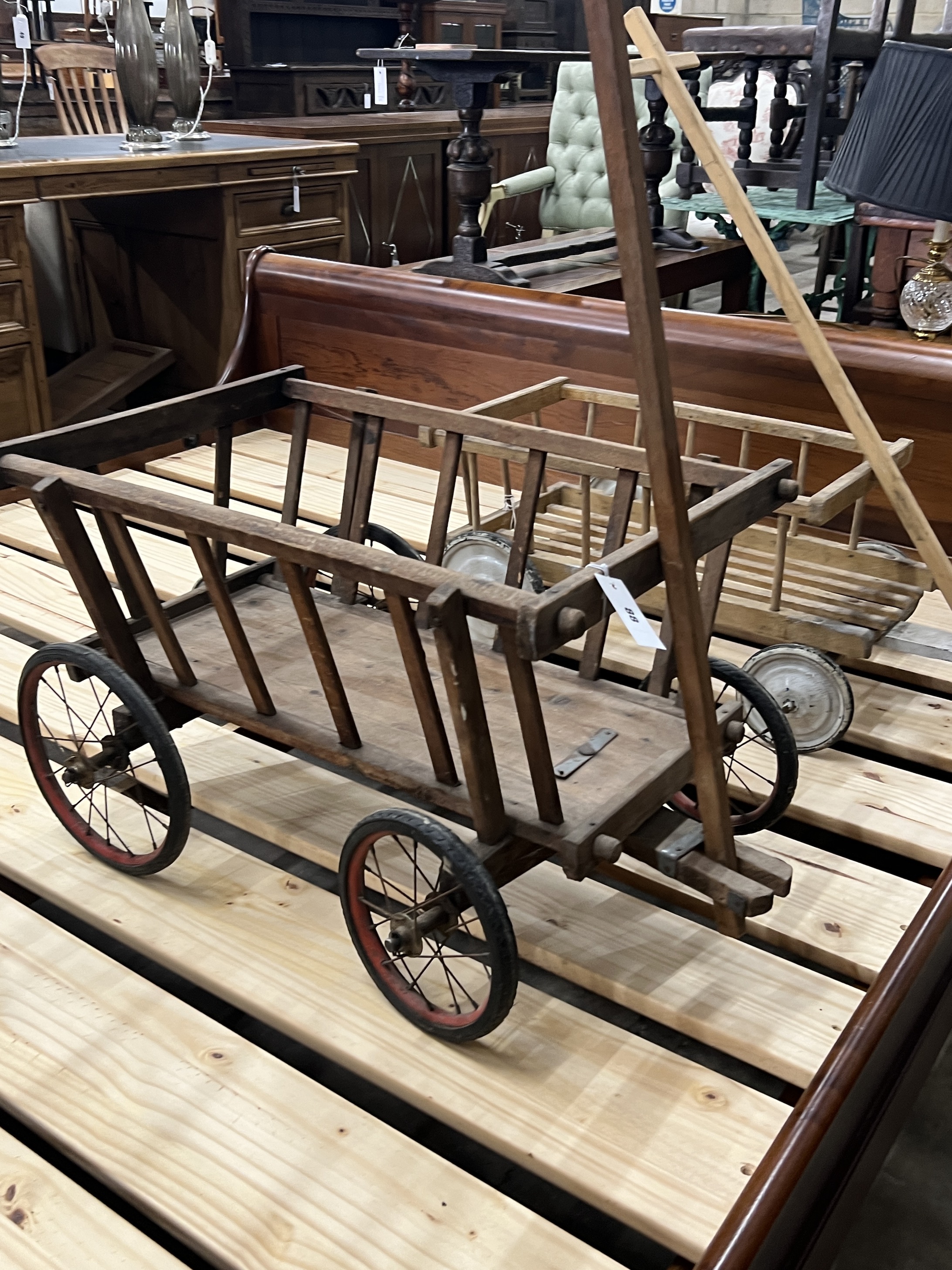 Two vintage pine and beech dog carts, larger length 70cm, width 48cm